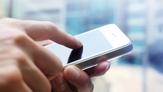 A guy using his cell phone. Image Source: americanprogress.org